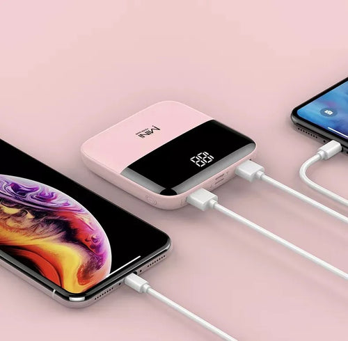 mini powerbank with two phones plugged into it for charging